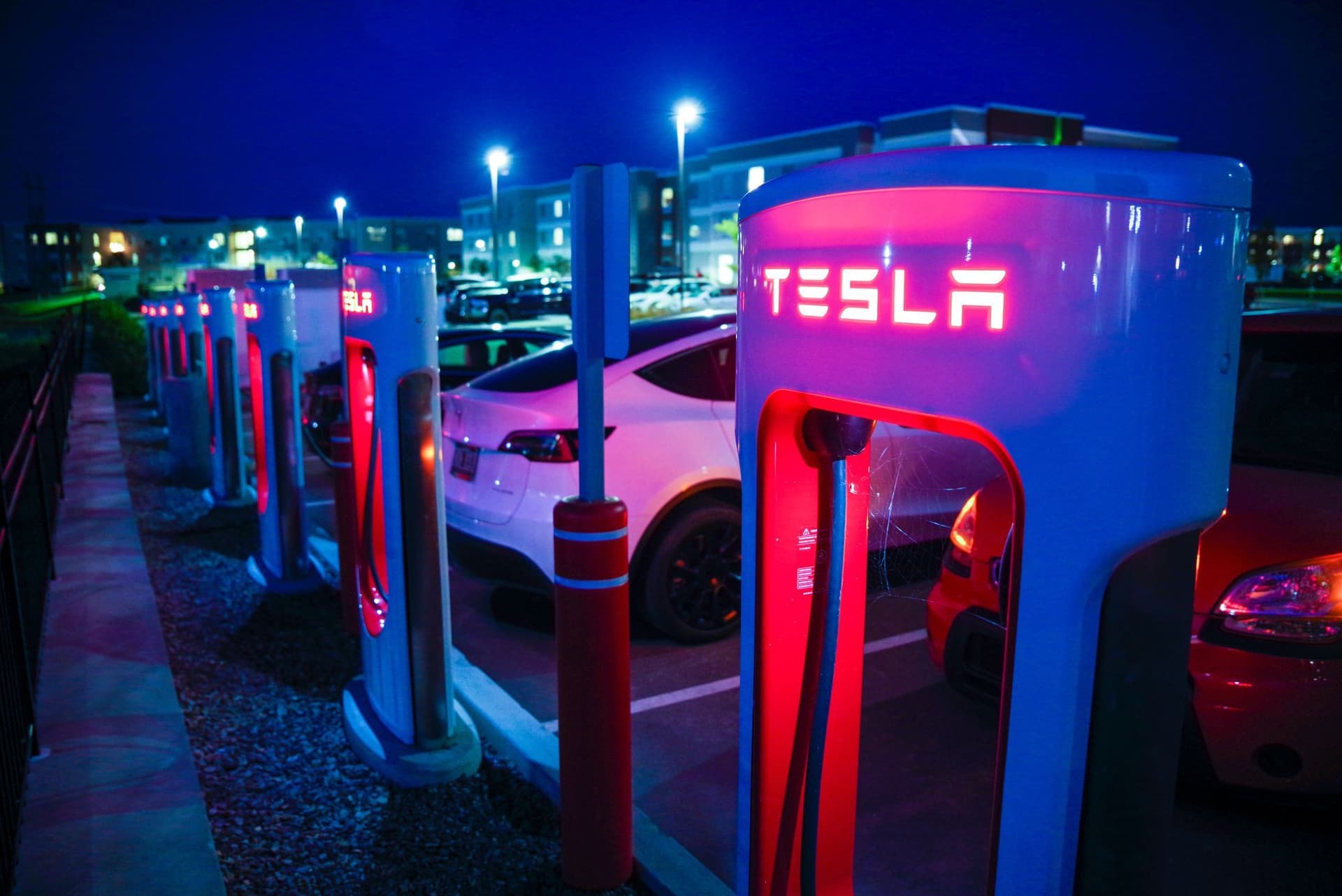 Tesla Superchargers with Teslas charging at night