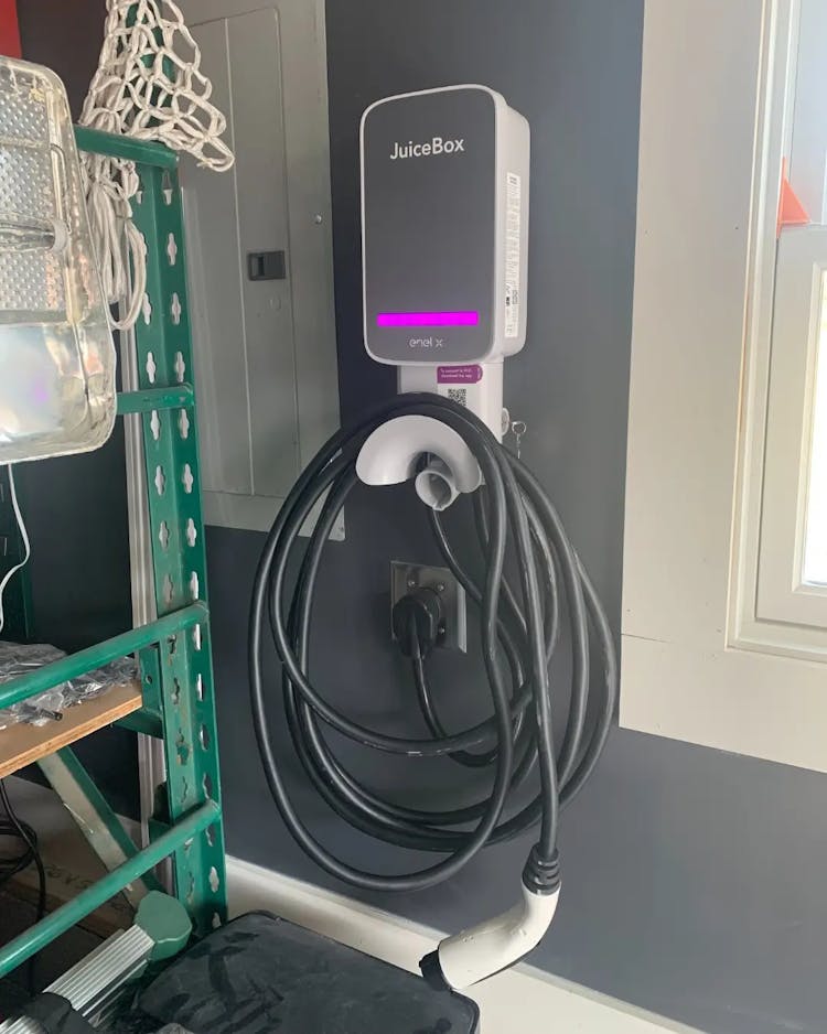 electric vehicle charger hanging in garage