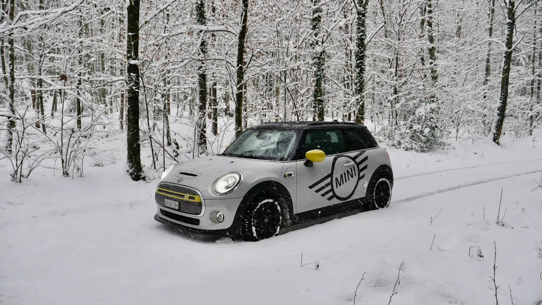 Grey mini cooper in snowy forest