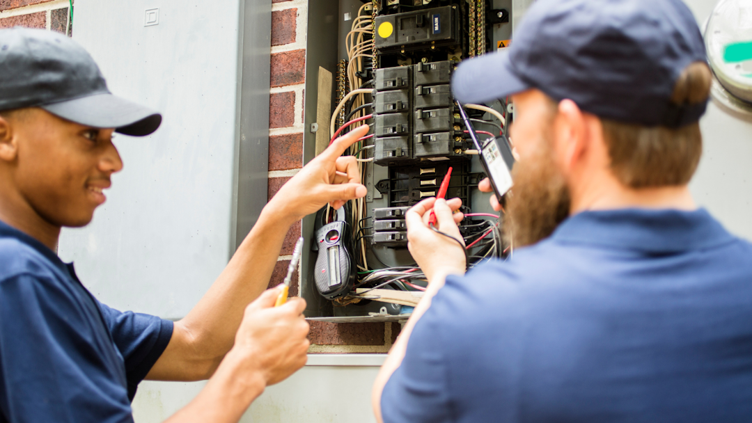 Electricians upgrading an electrical panel