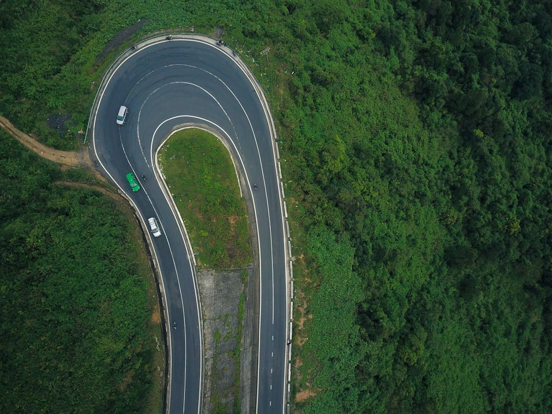 Aerial view of cars driving on a windy road 