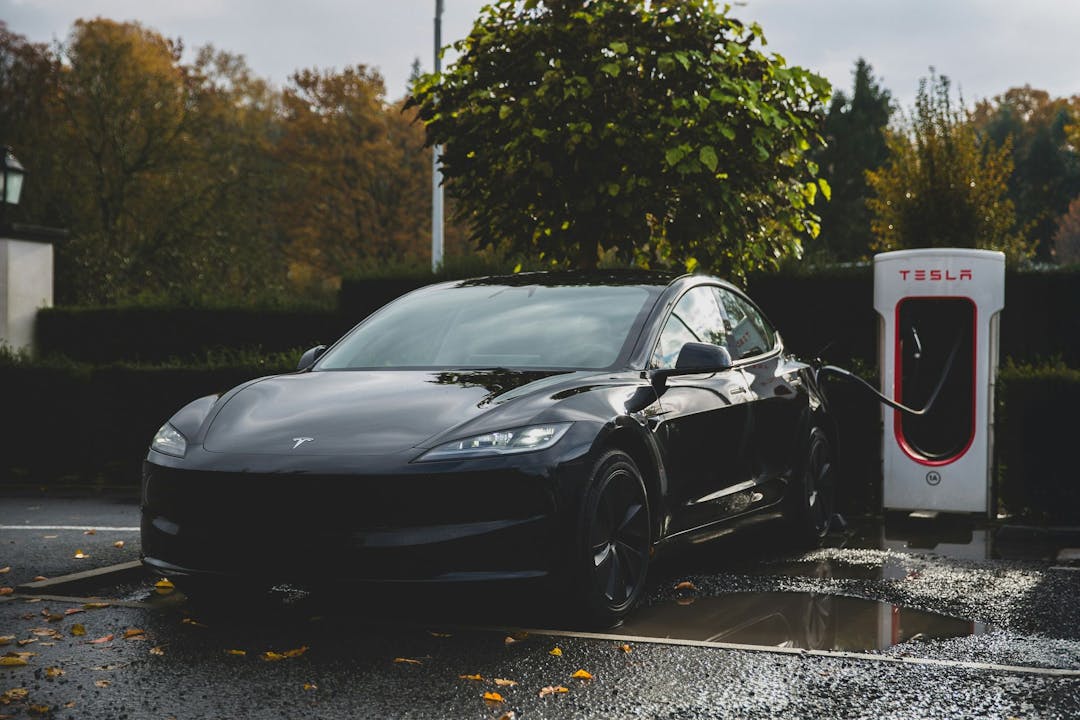 Black Tesla charging at a Supercharger station